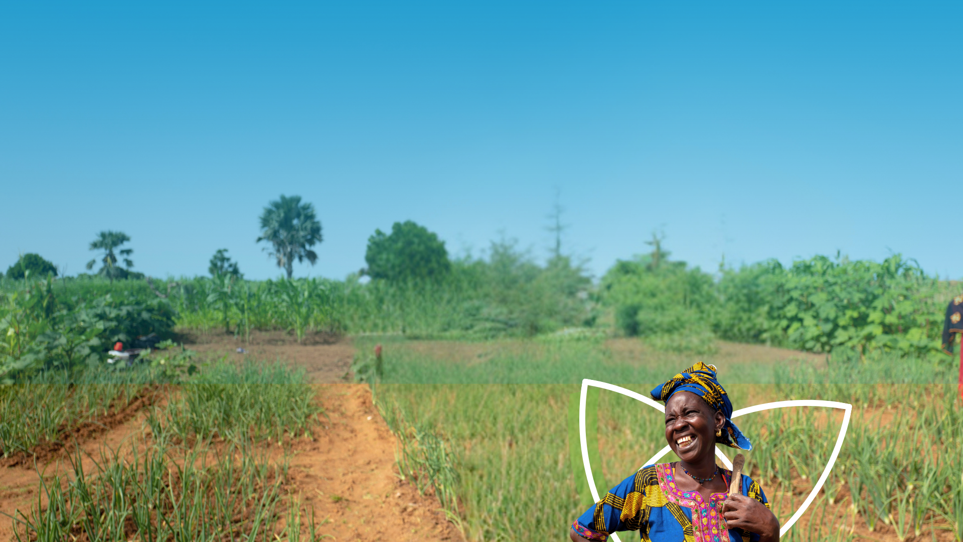 A women smiles in a field.