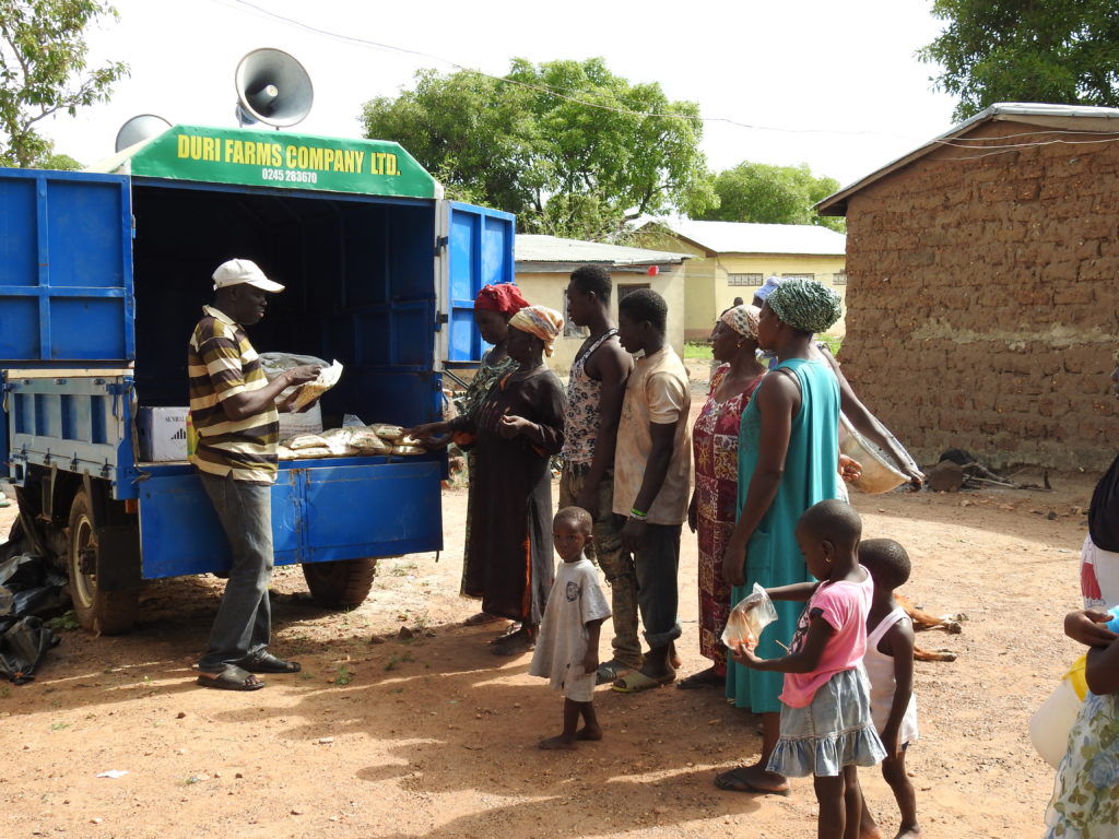 Photo of farmers buying seed from the seed van.