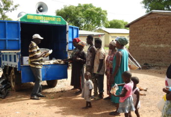Photo of farmers buying seed from the seed van.