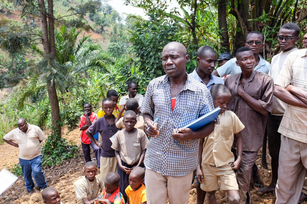 An instructor speaks to farmers in Benin.