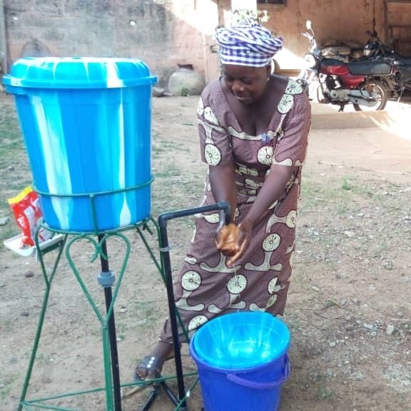 A woman washes her hands