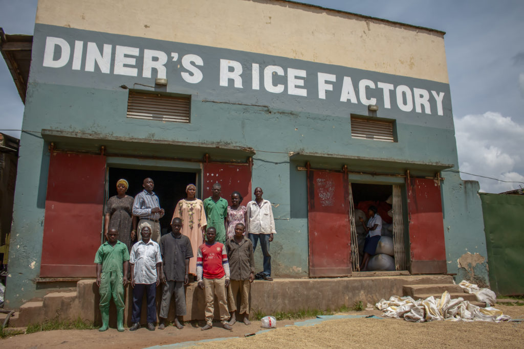 Workers at the Diner's Rice Factory stand in front of the business.