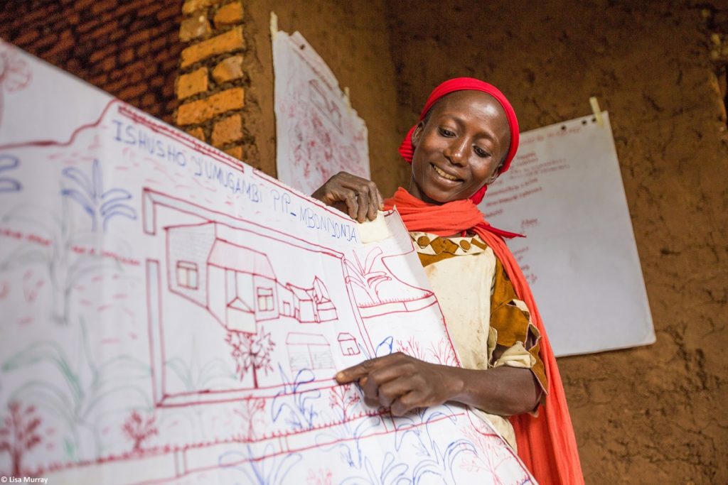 A woman displays her hand drawn plan