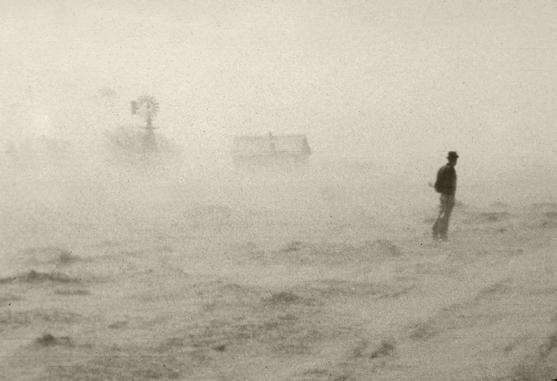 Wind erosion carries topsoil from farmland during the Dust Bowl, circa 1930's