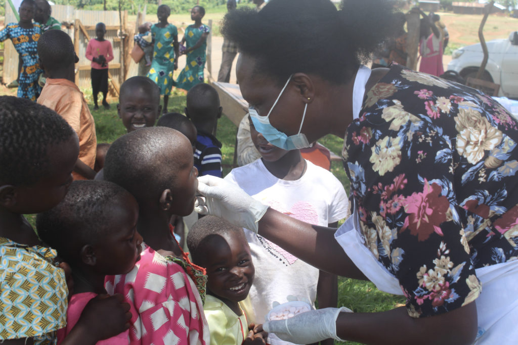 Woman giving vaccines to children