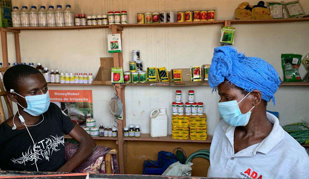 Flora and son posing in front of a shop in Nhamatanda.