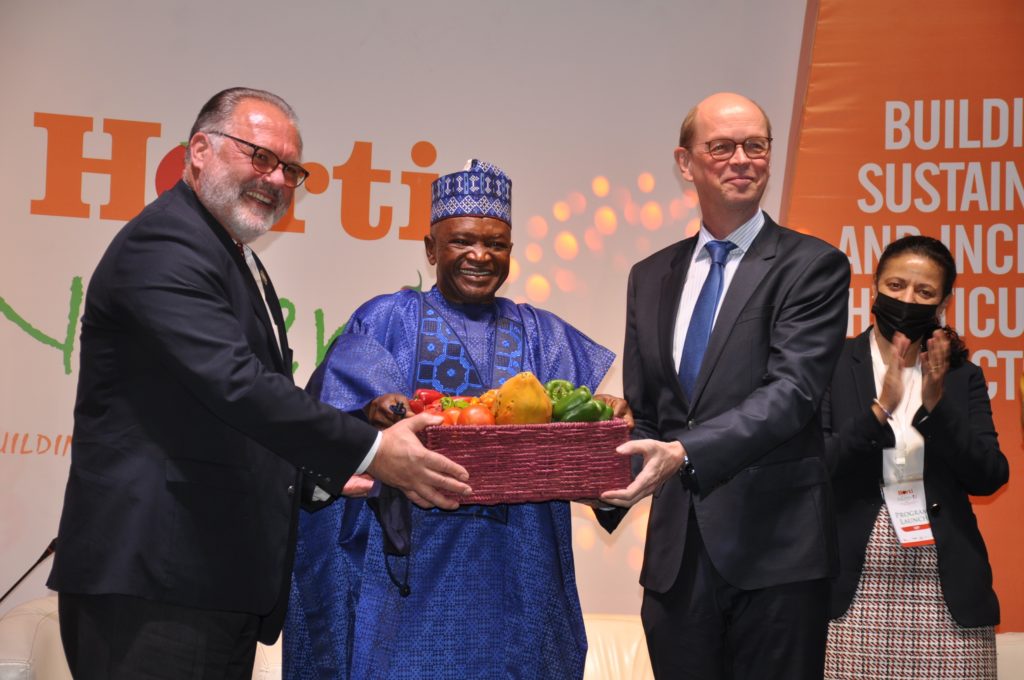 Albin Hubscher and Harry van Dijk present produce from Nigeria with another representative