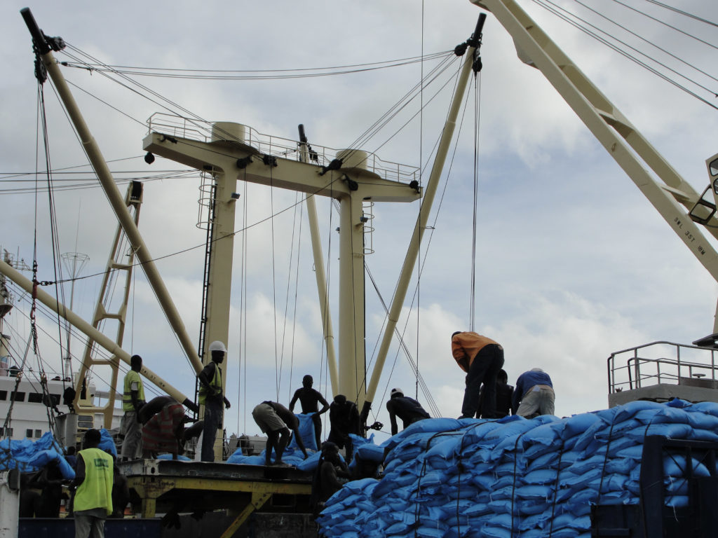 Men working on boat transporting fertilizer