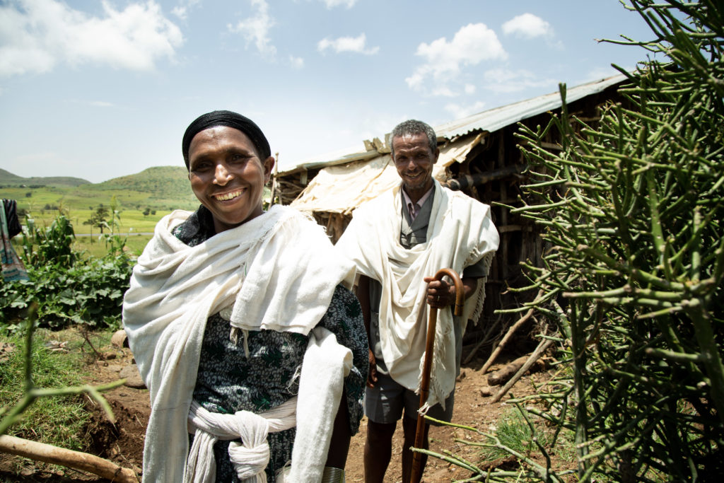 Man and woman outside farm building