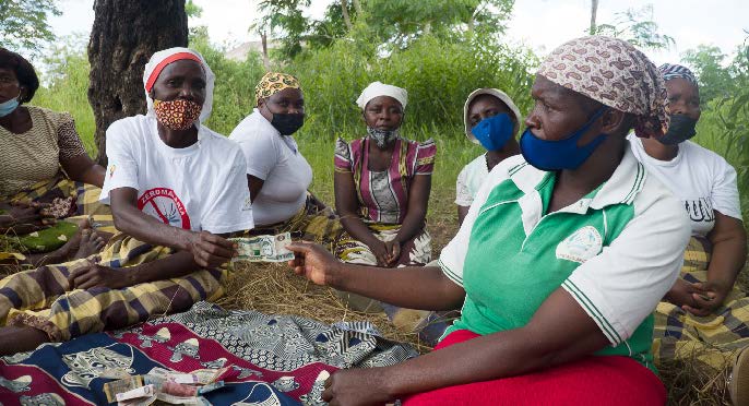 A group of women making their periodic contributions.