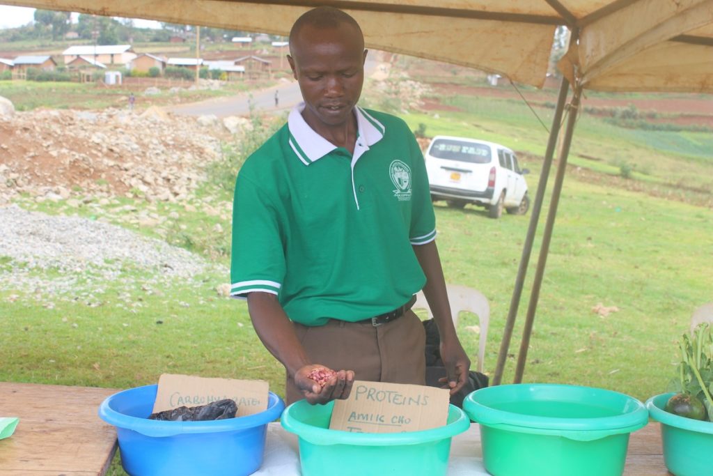 Kissa John shows seeds at an open day marketing event