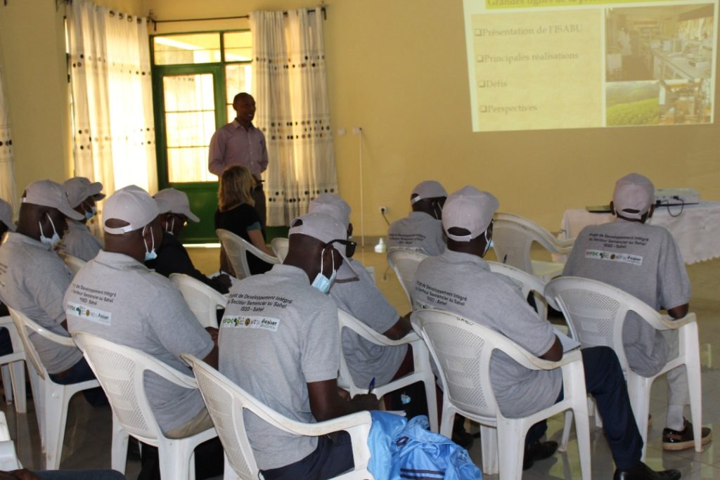 Visitors sit in a classroom during a knowledge-sharing presentation