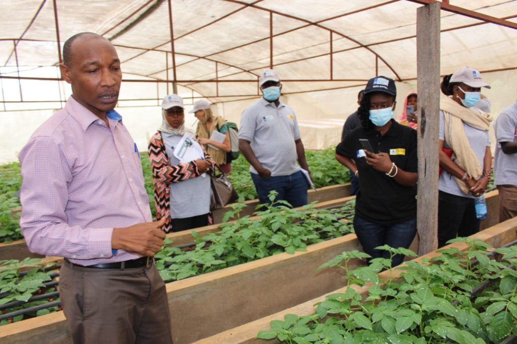 Participants are given a tour of a seed store house