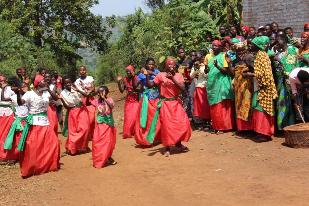 Community members dance and celebrate at the end of the visit