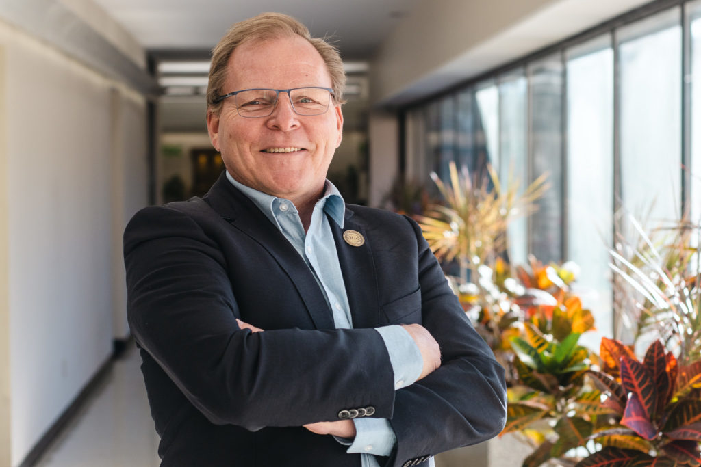 van duijn wearing a light blue shirt and navy blazer