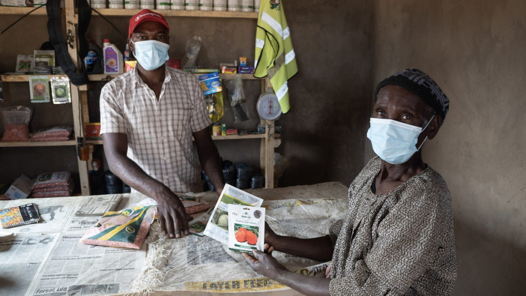 Agro-dealer and farmer display their quality seeds