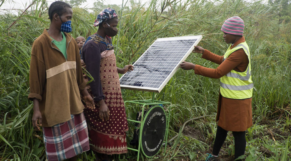 A farming couple from Mozambique learn how to operate a solar powered pump