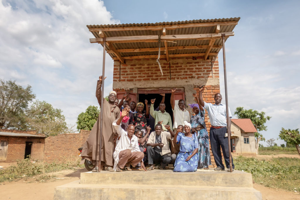 Members of the Idudi Rice Cooperative in Uganda joyfully pose for a picture