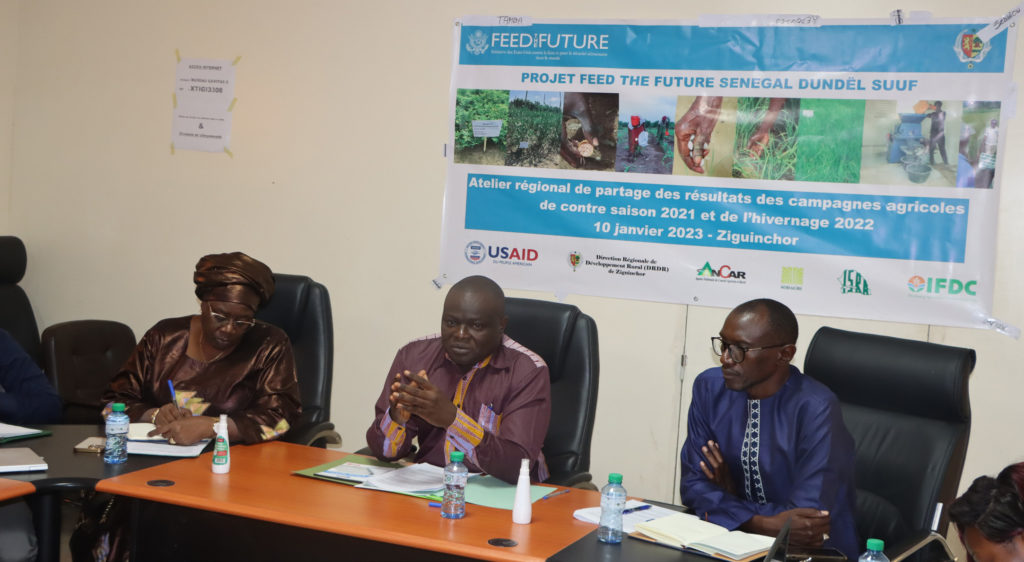 Three facilitators of the Ziguinchor workshop sit at a table