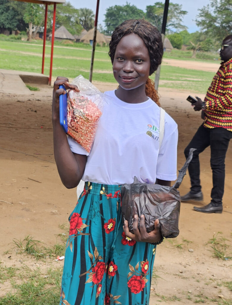 A young woman poses during a seed event in South Sudan
