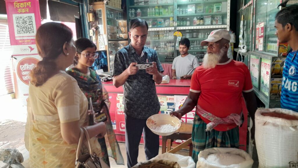 The delegation viewing fertilizer briquettes at a briquette shop. 