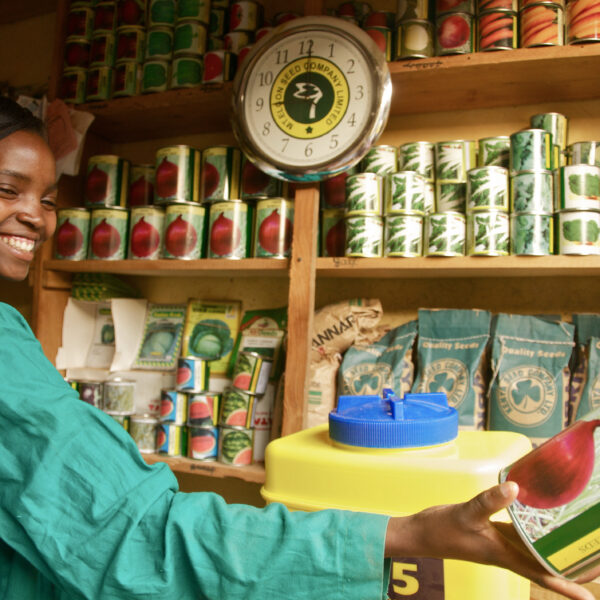 A young woman sells products from her market.