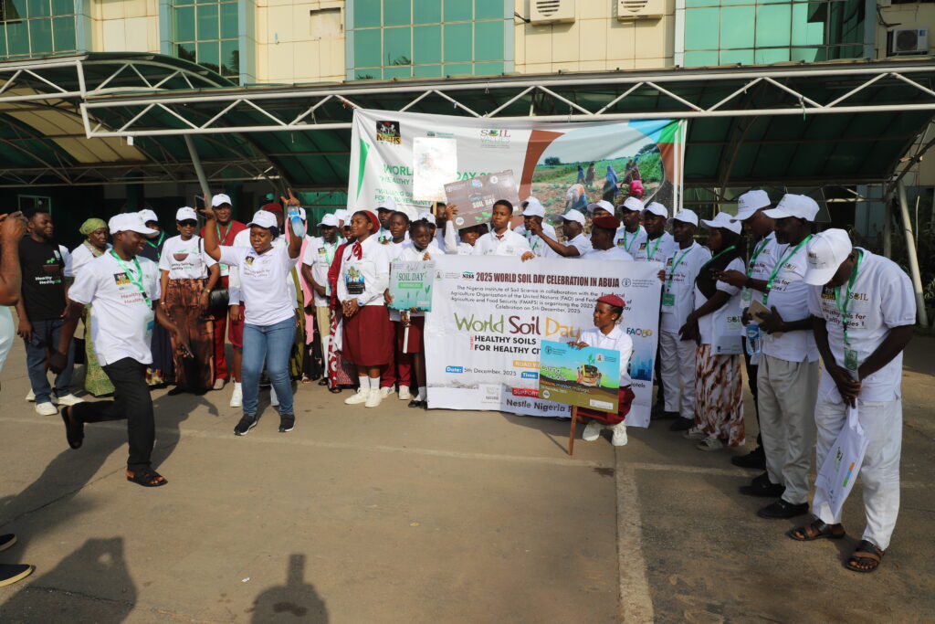 A group photo of Soil Values staff in front of a banner.