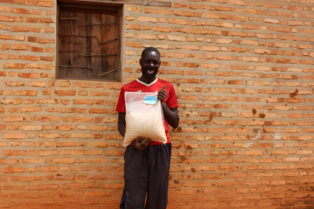 Jean Paul Nyandwi holding a bag of local maize seed.