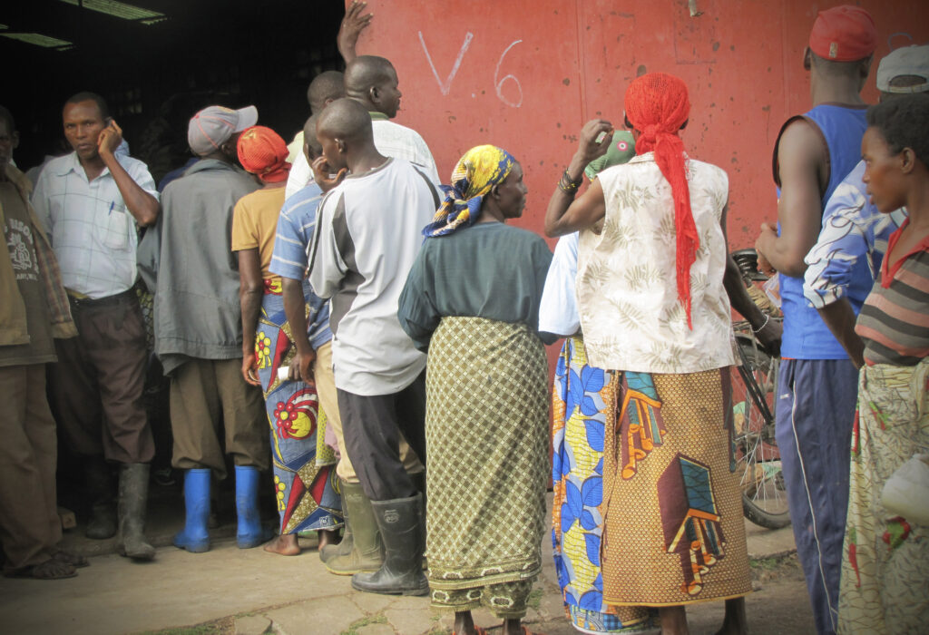 Farmers queue at a local warehouse to access fertilizer supplies.