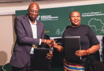 Bayella Thiam, Chief Operating Officer of IFDC (left), and Alice Ruhweza, President of AGRA (right), shake hands after signing the MoU.